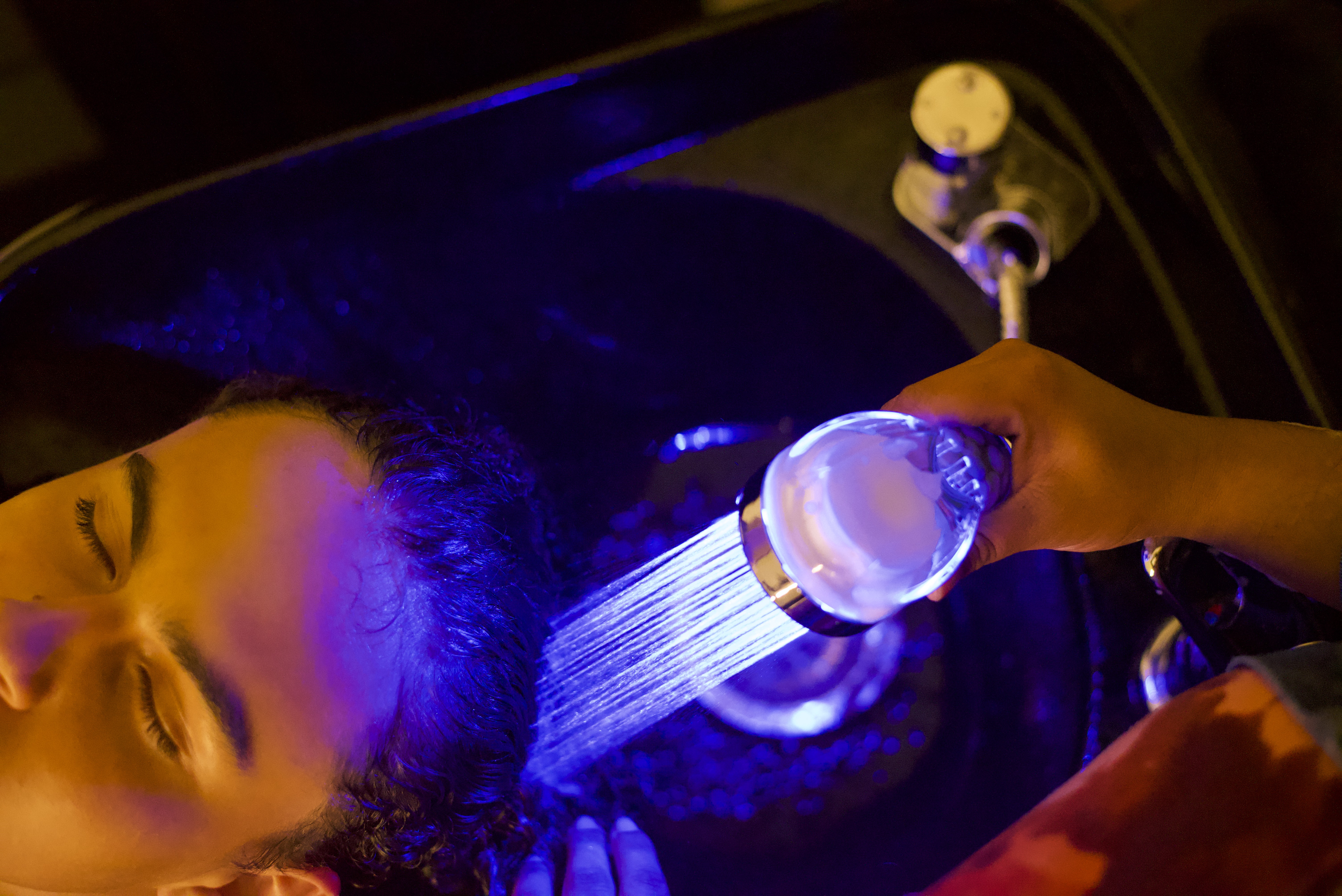 Stylist washing clients hair